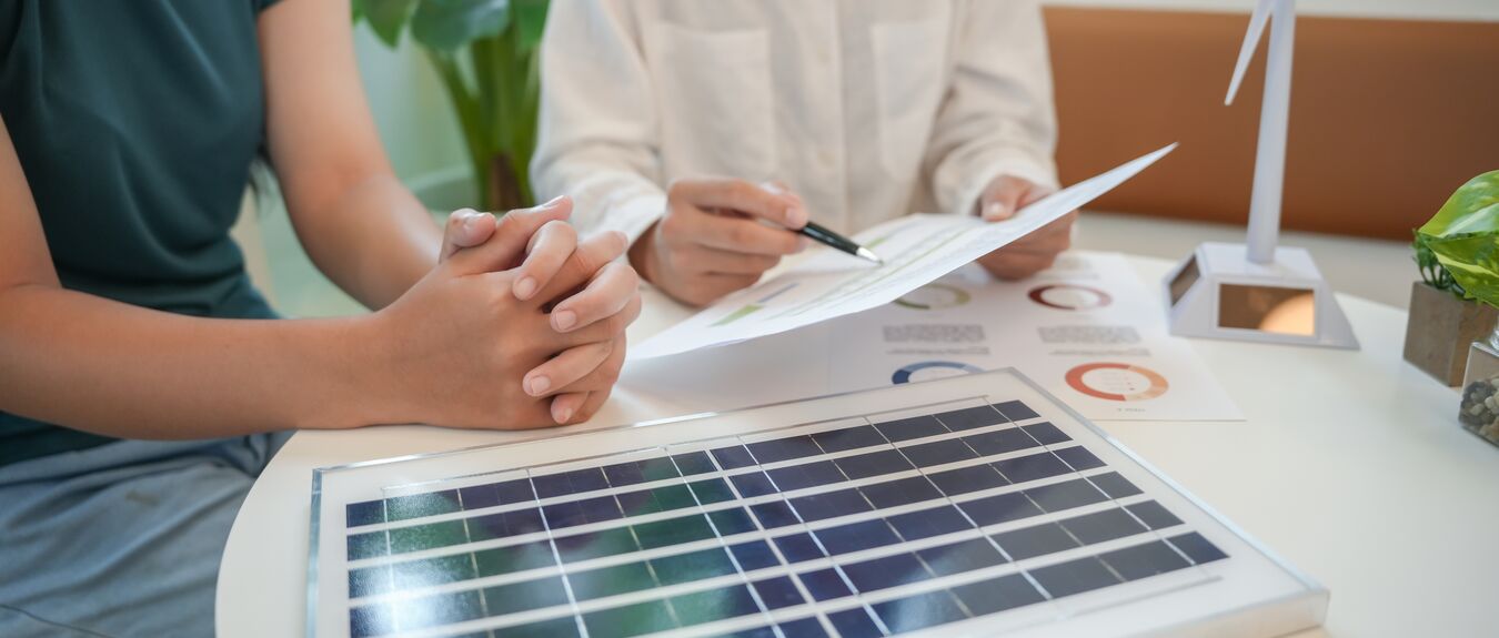 Solar panels green energy Business people working in green eco friendly office business meeting creative ideas for business eco friendly professional teaching corporate people sustainable electricity